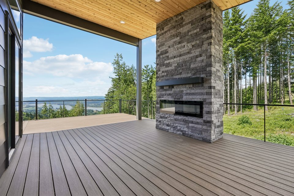 Covered deck with fireplace overlooking the river valley